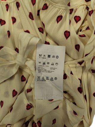 Beige Dress With Overall Heart Shaped Pattern And Open Back