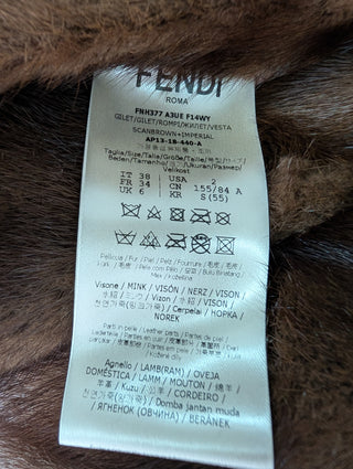 Brown Fur Vest With Blue Fur Frims And Logo Back Belt