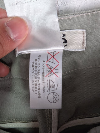 Washed Green Jeans With Stitching Details And Logo Button