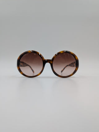 Brown Tortoise Round Sunglasses With Quilted Arms And Small Interlocking CC Logo On Side Arms
