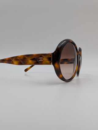 Brown Tortoise Round Sunglasses With Quilted Arms And Small Interlocking CC Logo On Side Arms
