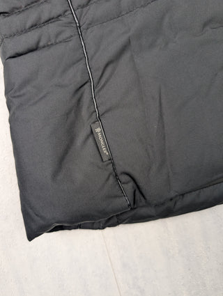 Black Puffer Vest Features Fur Trim On Collar And Circular Zipper Pull