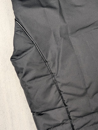 Black Puffer Vest Features Fur Trim On Collar And Circular Zipper Pull