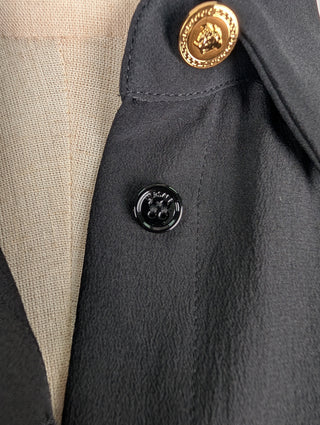 Black Button Up Top With Shoulder Pads And Gold Button At Top